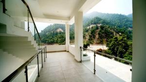 a balcony with a view of a mountain at Phool Chatti Yoga Ashram 7 day Yoga Retreat in Shivpuri