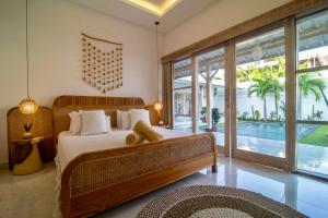 a bedroom with a bed and a pool at Simple & Magical Villas PRAYA in Seminyak +42 photos