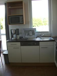 a kitchen with a sink and a microwave at Apartment Seestern in Großenbrode