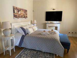 a bedroom with a bed with two towels on it at Stanze Degli Aceri in Murazzano