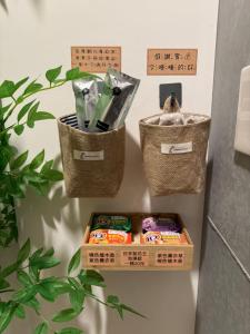 three baskets hanging on a wall with some food at 隱 Villa 旅宿 in Chaozhou
