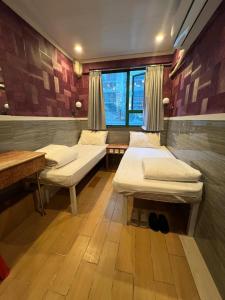 Voodi või voodid majutusasutuse 3D Inn Hong Kong Romance toas