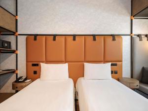 Uma cama ou camas num quarto em Ibis World Trade Centre