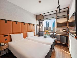 Uma cama ou camas num quarto em Ibis World Trade Centre