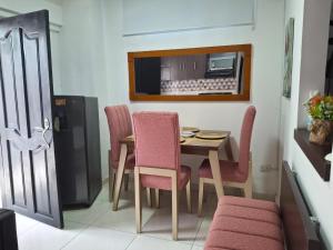 a dining room with a table and chairs and a refrigerator at Apartaestudio Monoambiente El Paraíso-Cerca al Gran Malecón del Río-Barranquilla in Barranquilla +5 photos