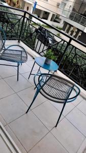 two chairs and a table on a balcony at 2 bedrooms flat near center in Engomi +3 photos