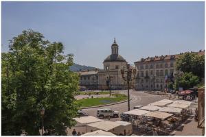 a large building with a street with tents in front of it at Carlina Charme 10 minutes from Porta Nuova - WIFI in Turin