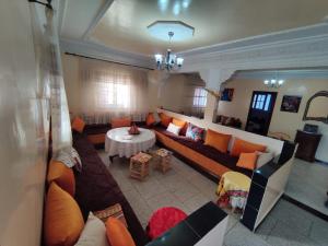 a living room with a couch and a table at Villa salma in Oualidia