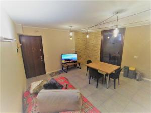 a living room with a couch and a table at Adamello Peak ONE Apartment in Temù
