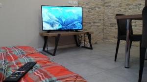 a television sitting on a table in a living room at Adamello Peak ONE Apartment in Temù