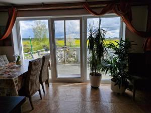 a dining room with a table and a sliding glass door at Ferienwohnung Adebar in Bechhofen +7 photos