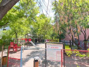 a playground in a park with a red gate at City Charm -3 rooms with free Parking in Iaşi