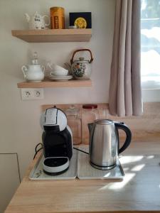 a coffee maker and kettle on a tray on a counter at Giverny, Cosy studio au vert in Giverny