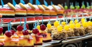 a bunch of cakes with cherries on top of them at The Marilis Hill Resort Hotel & Spa Ultra All Inclusive in Okurcalar