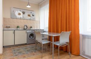 a kitchen with a table and chairs and a washing machine at Apartment on Maidan, Khreschatyk 4 street in Kyiv +6 photos