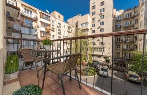 a balcony with chairs and a table and some buildings at Apartment on Maidan, Khreschatyk 4 street in Kyiv