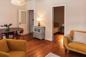 a living room with a couch and a table at SUNNY PATIO Apartment in Lisbon