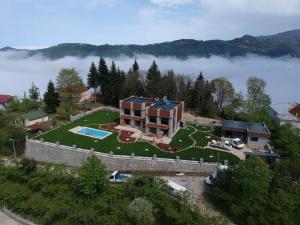 an aerial view of a house on a hill with a fence at villa trapeza in Trabzon