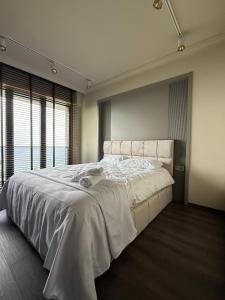 a bedroom with a large bed with a large window at villa trapeza in Trabzon +30 photos