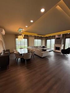 a large living room with a couch and a fireplace at villa trapeza in Trabzon