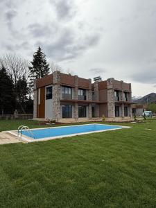 a house with a swimming pool in front of it at villa trapeza in Trabzon
