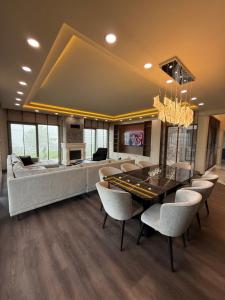 a living room with a ping pong table and chairs at villa trapeza in Trabzon
