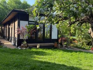 a small cottage with a porch and green grass at Amberlea in Stockbury