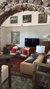 a living room with two beds and chairs and a table at Castillo Antonia Executive Villa with heated pool in Tías +72 photos