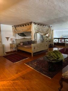 a living room with a bed with a canopy at Castillo Antonia Executive Villa with heated pool in Tías