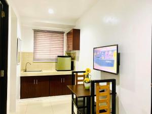 a kitchen with a table and chairs and a sink at The Seaside Residences in Manila