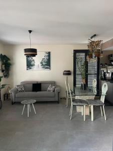 a living room with a couch and a table and chairs at Cœur du vieux Lyon et zone de loisir in Lyon