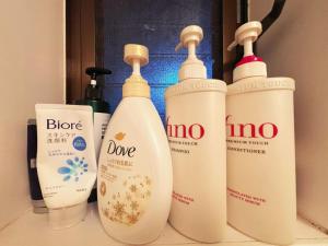 a group of four bottles of detergents on a counter at 花の郷田端b02 in Tokyo