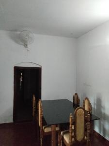 a dining room with a table and chairs at Ophel Ayurvedic Gardens, 7 Bed Heritage Home in Mananthavady