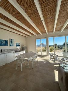 a dining room with a table and chairs at Villa Rebecca in Porto Cesareo +14 photos