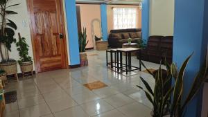 a living room with a couch and a table at KBC ZAI Baguio Staycation 1 in Baguio +20 photos