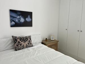 a bedroom with a white bed with a pillow on it at Austria 05 in Lebrija