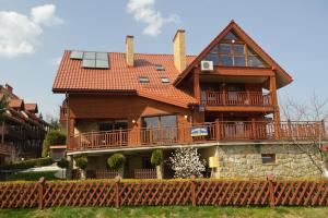 a large house with a balcony and a roof at Dom Gościnny Barbara in Polańczyk