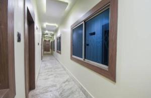 a corridor of a hospital with windows and a hallwayngth at Hotel Eden Park in Nimtita +1 photo