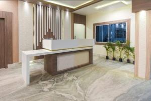 a lobby with a reception desk in a building at Hotel Eden Park in Nimtita