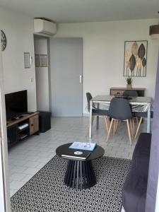 ein Wohnzimmer mit einem Tisch und ein Esszimmer in der Unterkunft Home cavalaire in Cavalaire-sur-Mer