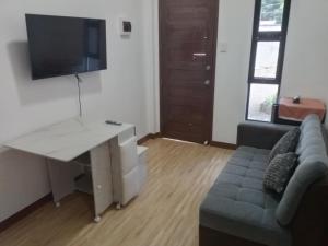 a living room with a desk and a couch at BMR Apartment-Unit 2 in Dipolog