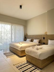 a bedroom with two beds and a window at Alraha VIP Marsa zayed Aqaba in Aqaba +58 photos