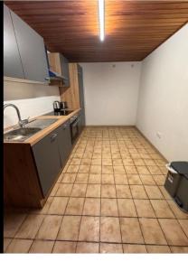 a kitchen with a sink and a tiled floor at Rösrath Wohnung mit Küche in Rösrath