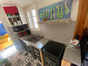 a small kitchen with a sink and a stove at Maison de charme à 300m de la plage in Saint-Pierre-dʼOléron +5 photos
