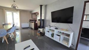 a living room with a flat screen tv on a wall at Beautiful Family House near Paris in Villeneuve-Saint-Georges