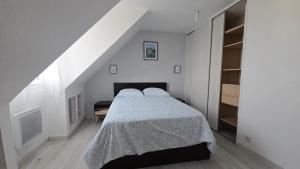 a white bedroom with a bed and a staircase at Beautiful Family House near Paris in Villeneuve-Saint-Georges