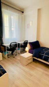 a bedroom with a bed and a desk and chairs at Muzien B&B in Imola +9 photos