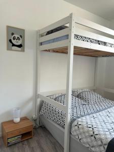 a bedroom with two bunk beds and a table at Le Parmentier - 1 place de parking privative in Saint-Aignan