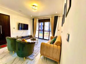 a living room with two couches and a television at Luxe Home in Nalakonge