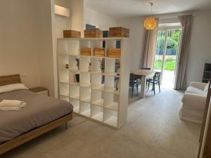 a bedroom with a bookcase with a table and a dining room at Locanda Francini in Badia A Passignano